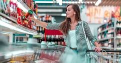 beautiful woman with shopping cart at supermarket