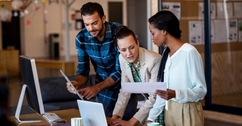 young multi-ethnic business people working at computer desk