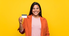 Young woman holding a credit card