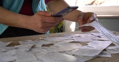 A person scans a paper receipt using their phone.