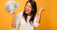 cheerful young woman holding money