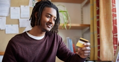 College student looking at credit card