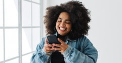 Smiling woman using her phone
