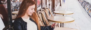 Woman sitting outside cafe