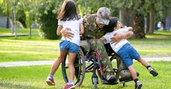 Disabled veteran hugging children