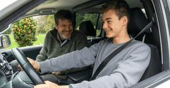 Father teaching teen son to drive