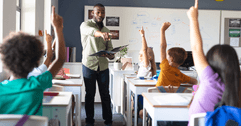 Teacher with students with hands raised