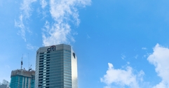Citibank skyscraper against a blue sky with clouds