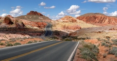 Nevada road cutting through desert mountains