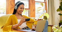 Girl on laptop with debit card