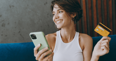 Smiling woman using credit card