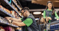Grocery store workers stocking shelves