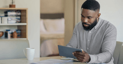 Man doing online banking on tablet