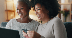 Friends shopping online with credit card