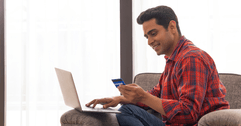 Man on laptop with credit card