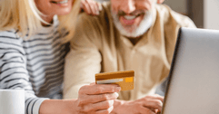 Older couple using a credit card online