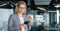 Woman with credit card on her phone
