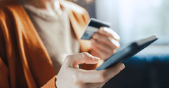 Woman's hands with phone and credit card