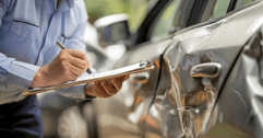 Car insurance adjuster evaluating accident
