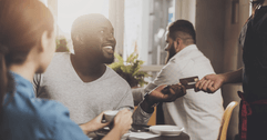 Man using credit card at restaurant
