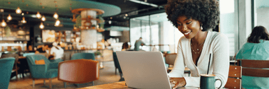 Young woman on laptop at coffee shop