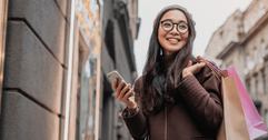 person with shopping bags and phone