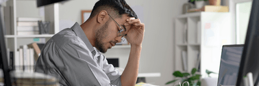Man looking stressed at computer