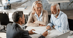 Financial advisor sitting with older couple