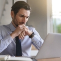 businessman concentrating on laptop in modern office