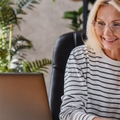 beautiful elderly businesswoman speaking on smart phone while working