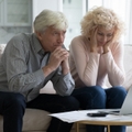 mature husband and wife frustrated about overspending family budget 