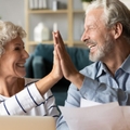 elderly couple giving high five
