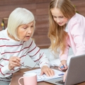 female grandchild and her granddaughter looking at the calendar