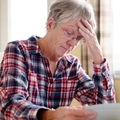 stressing senior lady reading document