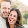 mature couple smiling while hugging each other 
