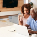senior couple using laptop to check finances
