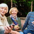 cheerful seniors enjoying time together drinking tea