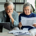 asian senior couple checking and calculate financial billing 