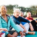 multi-ethnic seniors doing yoga in park