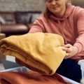 woman sorting out clothes in donation box for charity