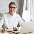talented mature woman writer sitting in front of laptop