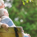 elderly couple resting on a bench