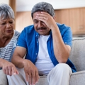 stressed senior couple reviewing bills