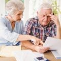 stressed senior couple reviewing bills