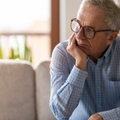 worried senior man sitting alone