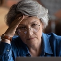 confused senior woman using laptop