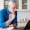 mature man looking at laptop