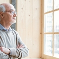 senior man gazing through window