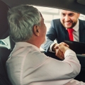 senior man buying car from dealer