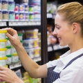 blonde worker keeping products in shelf